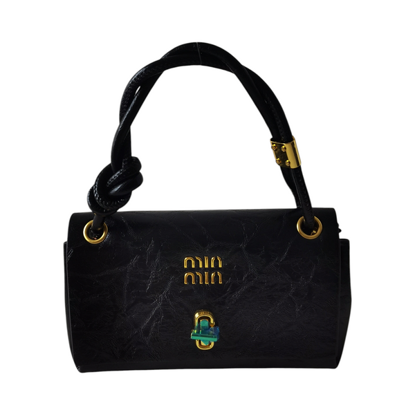 Cartera pequeña negra ZEFORA con textura, asas superiores y detalles metálicos dorados en un diseño elegante.
